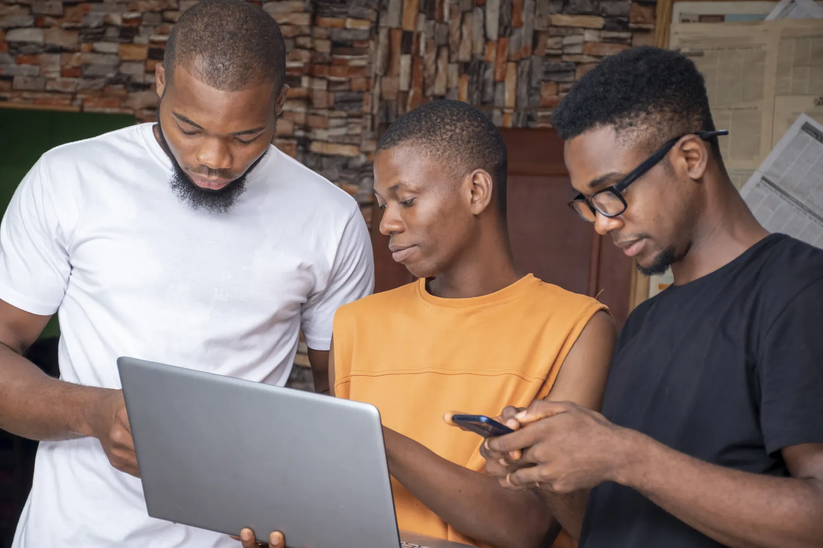 A team talking through a project with laptops and phones